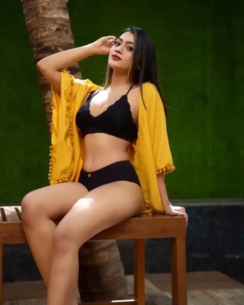 Aarohi, a highly trusted choice for escorts in Emirates Hill, smiling warmly in a luxury room.
